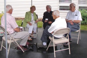 Father Madej and friends enjoy coffee and conversation at last year's picnic.