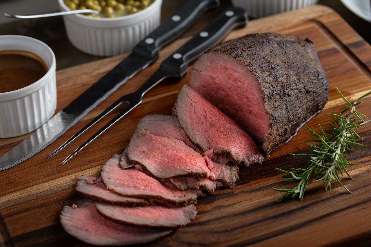 eye of round roasted beef with gravy sauce, potato and peas